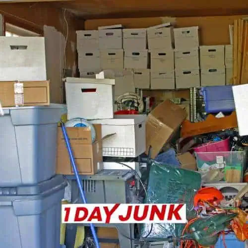 Overloaded storage room with boxes and clutter before professional junk removal service by 1DayJunk