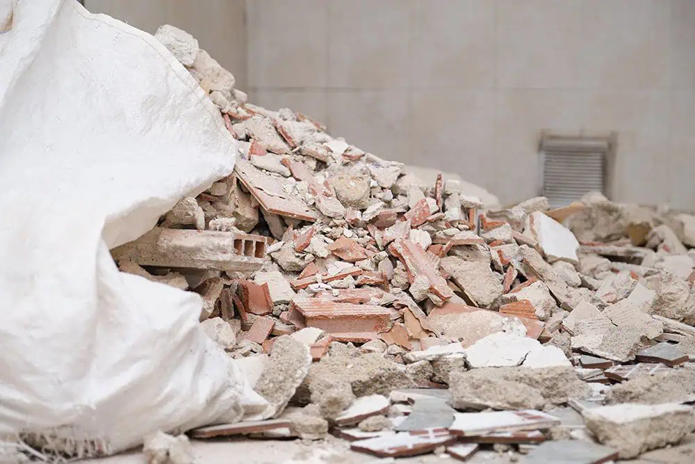 Pile of construction debris with broken bricks, plaster, and rubble