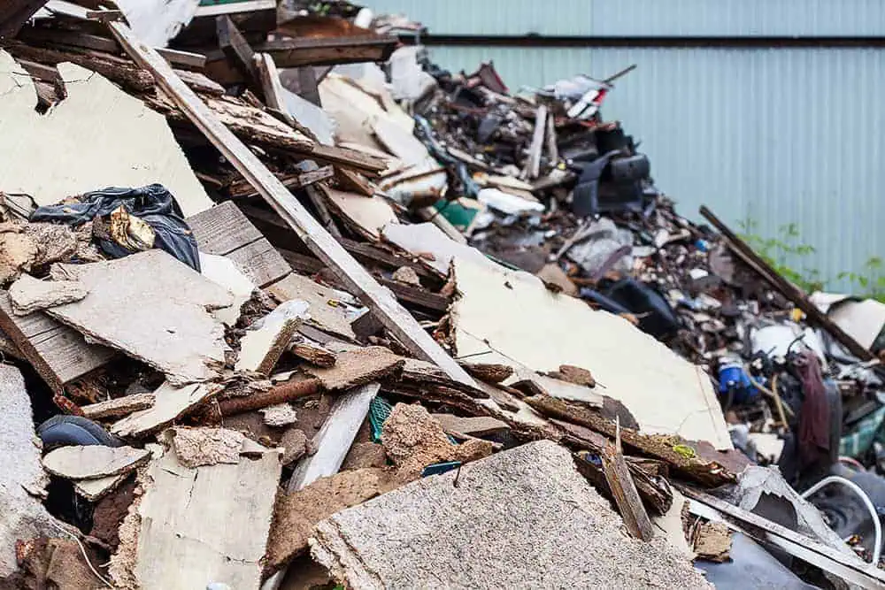 Large pile of mixed construction debris including wood, metal, and insulation