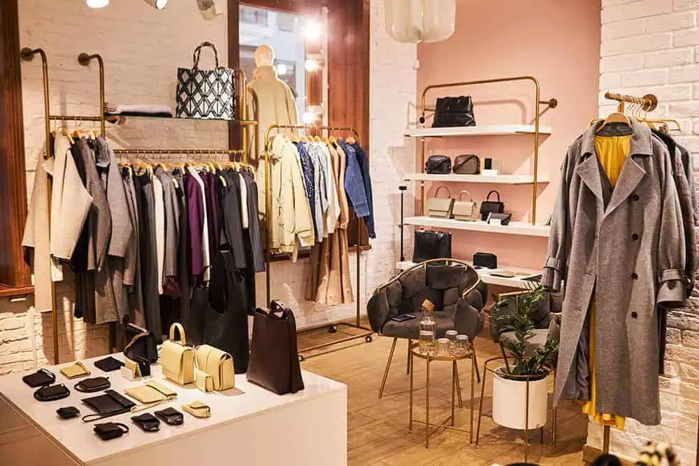 Stylish boutique clothing store with neatly arranged coats, handbags, and accessories